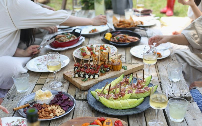 group of people eating on backyard